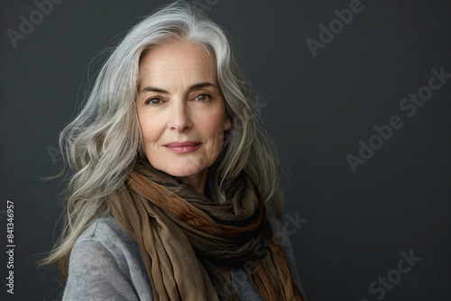 a woman with grey hair and a scarf