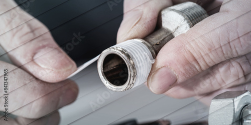 Obraz na płótnie Plumber putting a teflon joint on a thread, geometric pattern