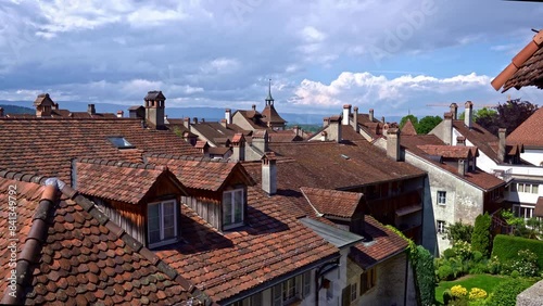 Panning of rooftops of medieval old town of Swiss City of Murten Morat on a cloudy spring day. Movie shot June 5th, 2024, Murten Morat, Switzerland.