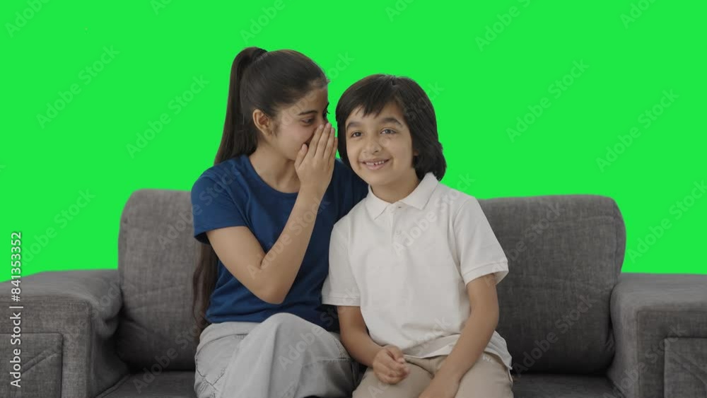 Indian sister telling a secret to her brother Green screen Indian sister telling a secret to her brother Green screen