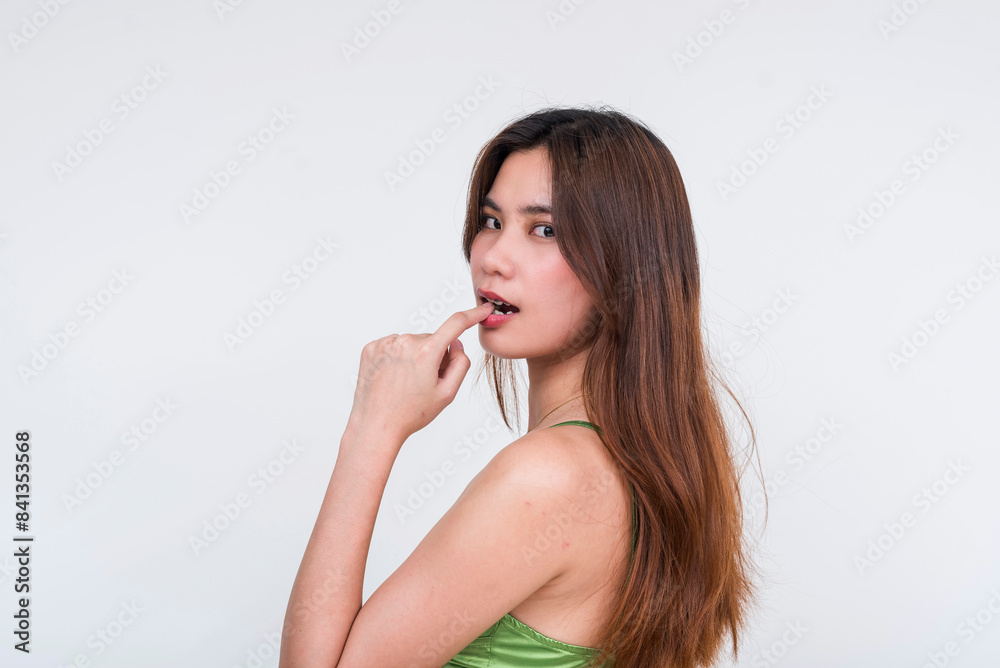 Pretty lady in light green silk dress biting her finger Pretty lady in light green silk dress biting her finger