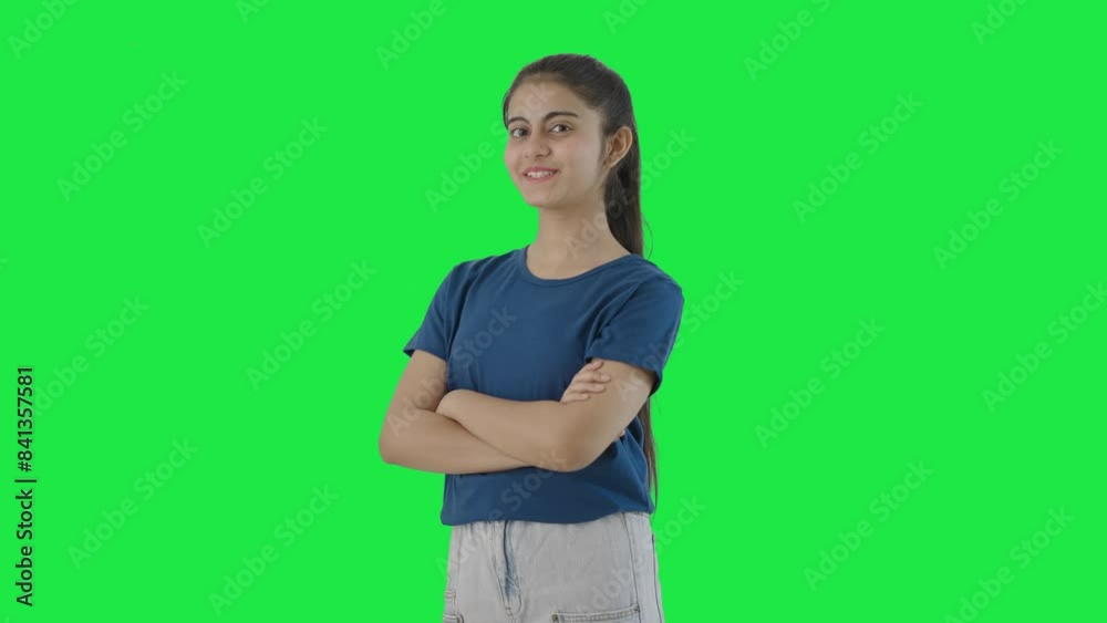 Portrait of Happy Indian teenage girl standing crossed hands Green screen Portrait of Happy Indian teenage girl standing crossed hands Green screen
