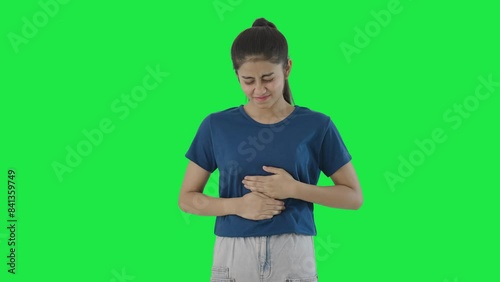 Indian teenage girl having stomach pain Green screen photo