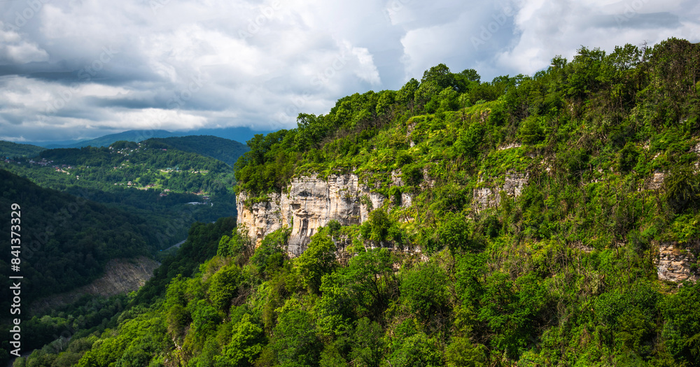 View of a beautiful mountainous area. Sunny afternoon. Beautiful spring landscape in the mountains. Rocks and dense forest. View of a beautiful mountainous area. Sunny afternoon. Beautiful spring landscape in the mountains. Rocks and dense forest.