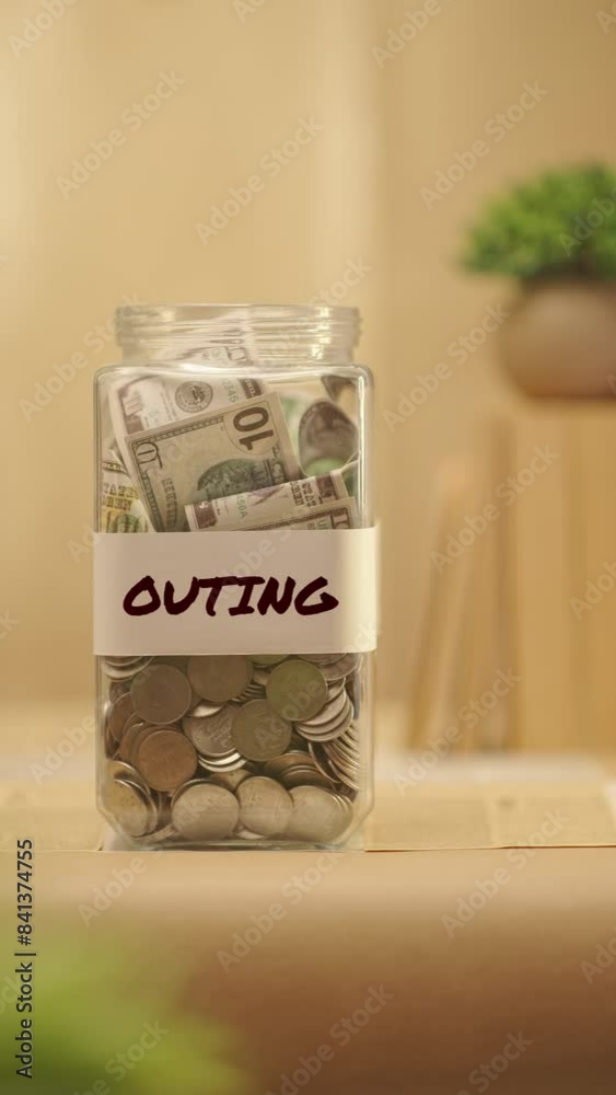 VERTICAL VIDEO OF PERSON SAVING MONEY FOR OUTING VERTICAL VIDEO OF PERSON SAVING MONEY FOR OUTING
