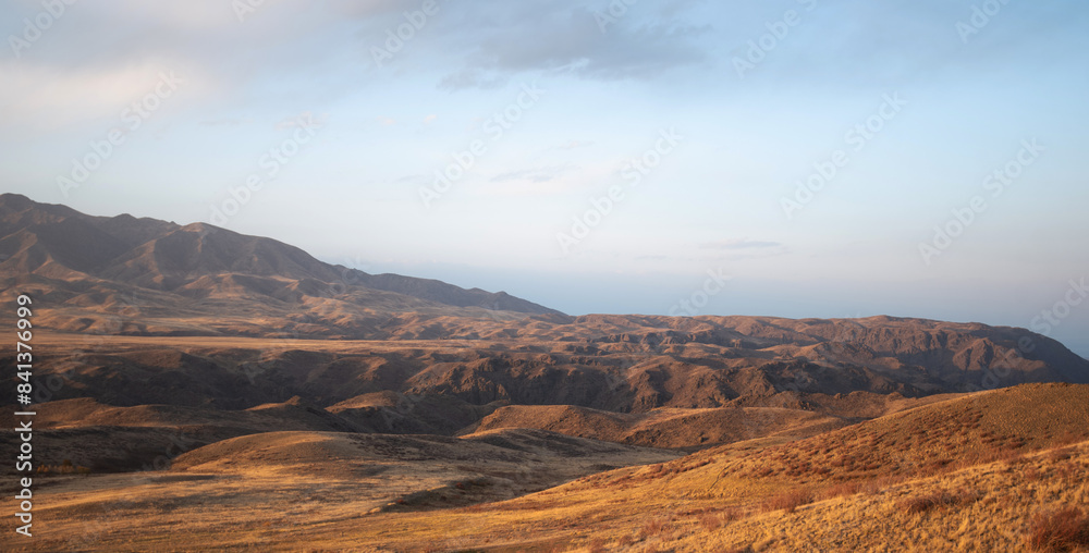 Fototapeta premium Autumn landscape of vast plains in China. Breathtaking, amazing, endless desert mountain landscapes bordering the Gobi Desert.