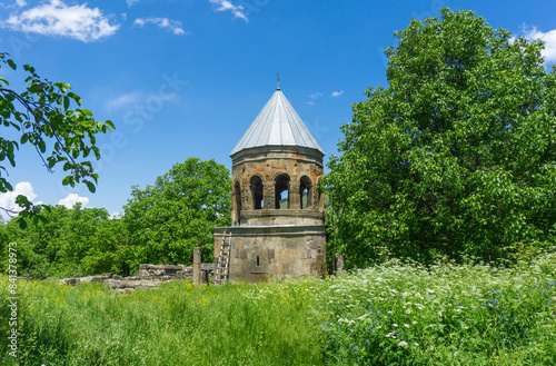 Dome of Saint Barbare church of Kheoti village among trees and bushes.