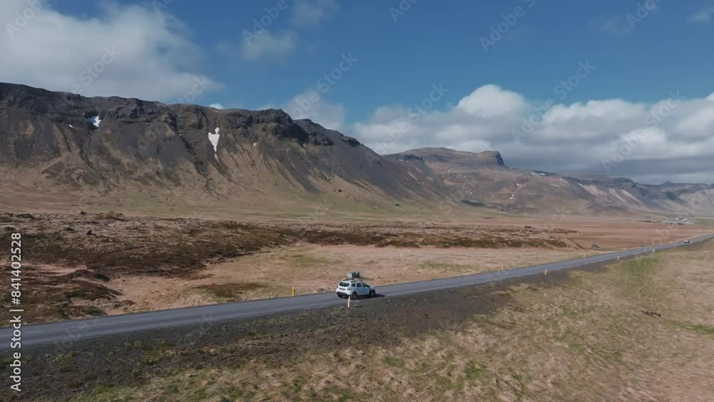 SUV car driving on beautiful road in Iceland, travel background. Aerial scenic landscape from Iceland of the roadtrip in a car down the roads and off roads. SUV car driving on beautiful road in Iceland, travel background. Aerial scenic landscape from Iceland of the roadtrip in a car down the roads and off roads.