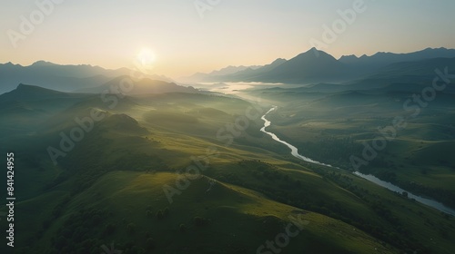 Majestic Sunrise Over Breathtaking Mountain Range with Rolling Hills, Valleys, and Sunlit Peaks