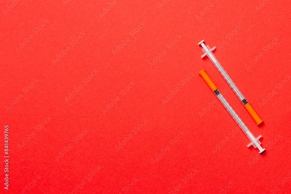 Top view of two insulin syringe at colorful background with copy space. High level of glucose concept Top view of two insulin syringe at colorful background with copy space. High level of glucose concept