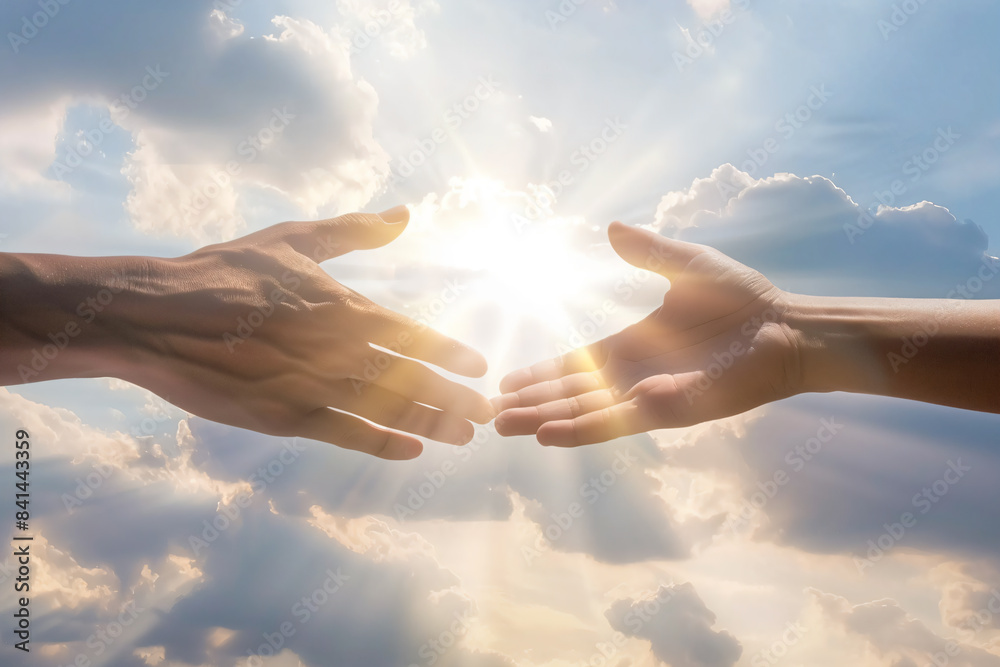 two hands reaching towards each other in front of a cloudy sky two hands reaching towards each other in front of a cloudy sky