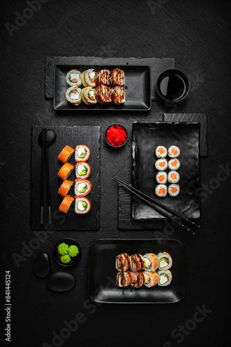 Sushi set composition on black background. The Art of Japanese Cuisine. Food photography for menu and sushi bar decoration