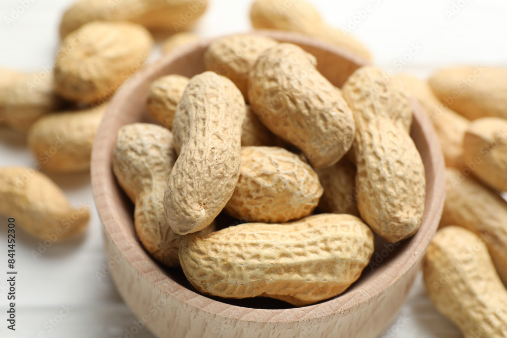 Fresh peanuts in bowl on table, closeup Fresh peanuts in bowl on table, closeup