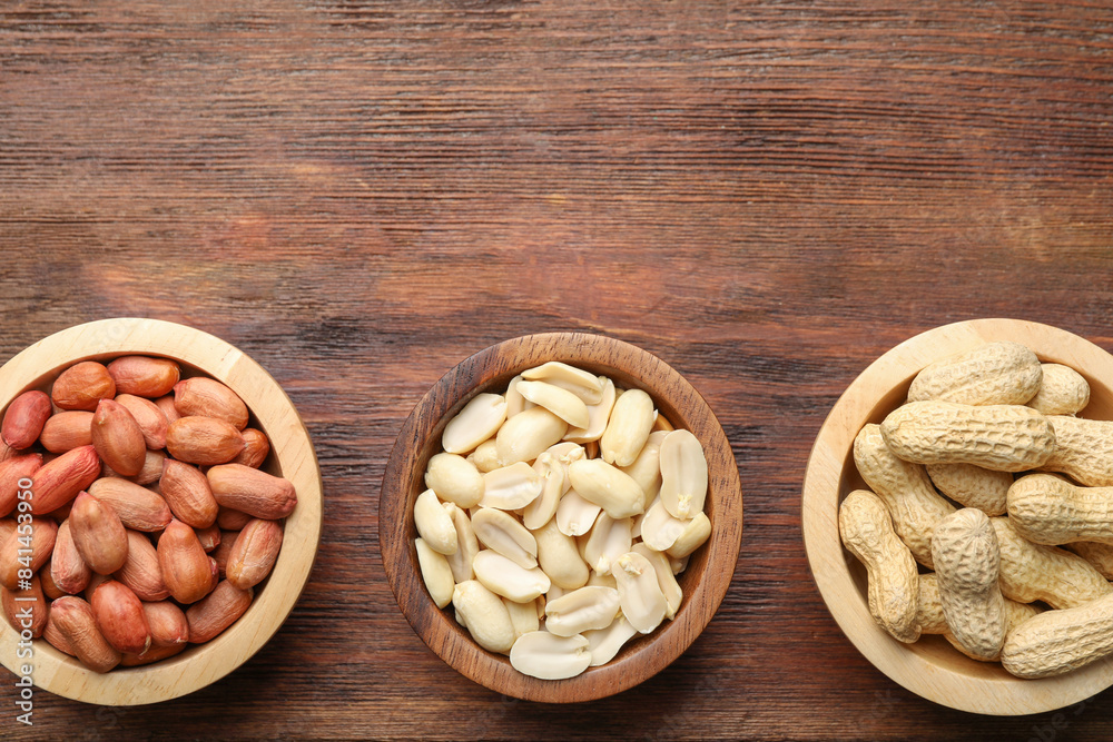 Fresh peanuts in bowls on wooden table, top view Fresh peanuts in bowls on wooden table, top view