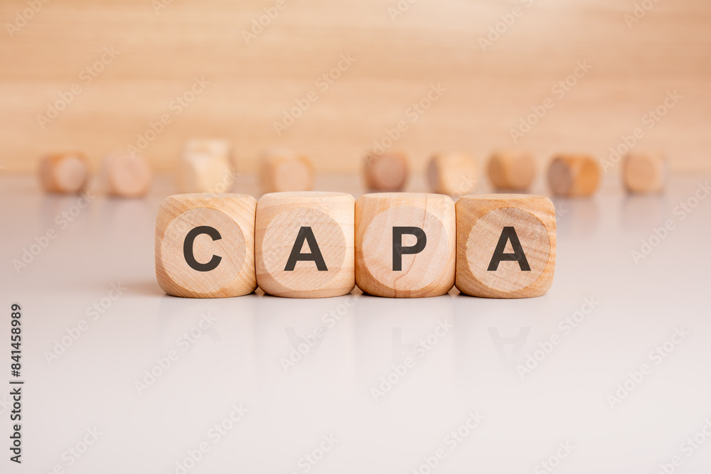 the word CAPA is elegantly displayed on a beige hardwood rectangle block the word CAPA is elegantly displayed on a beige hardwood rectangle block