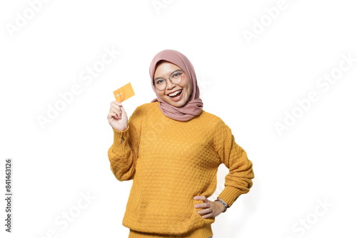 Excited young Asian woman holding credit card, online shopping isolated over white background