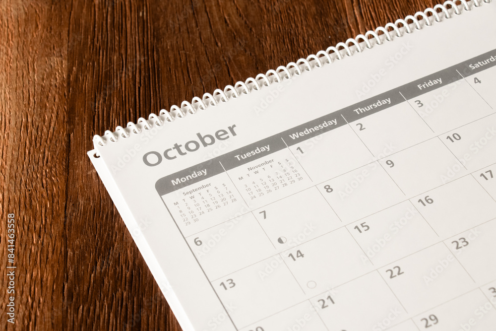 White calendar of the month of October on a wooden background. Planning, goal setting, agenda, planner, organization and time management concept. White calendar of the month of October on a wooden background. Planning, goal setting, agenda, planner, organization and time management concept.