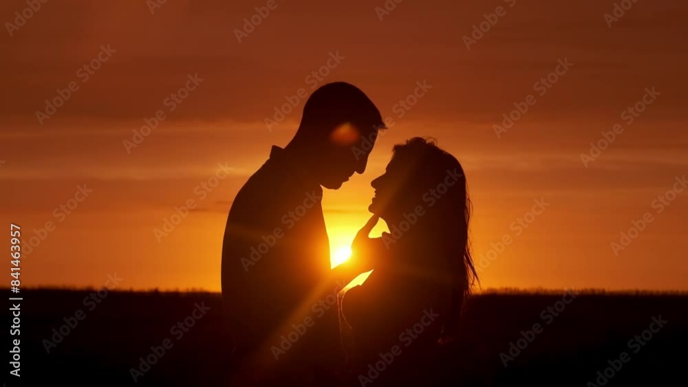 Silhouette, beach and couple at sunset kiss for bonding, together and relationship by ocean. Dating, nature and man and woman with affection and love for romance on honeymoon, vacation and weekend