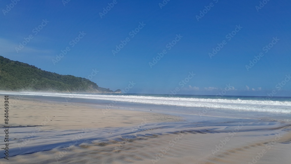 Beautiful beach with waves breaking on the rocks, Malang Modangan, East Java, Indonesia Beautiful beach with waves breaking on the rocks, Malang Modangan, East Java, Indonesia