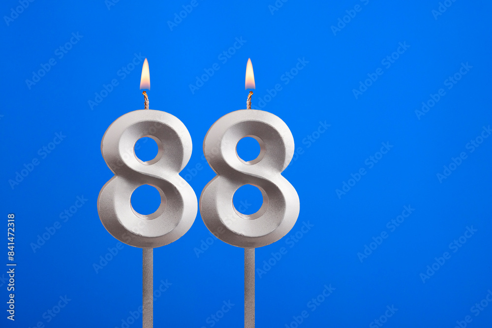 Birthday candle number 88 - Celebration card on blue background Birthday candle number 88 - Celebration card on blue background