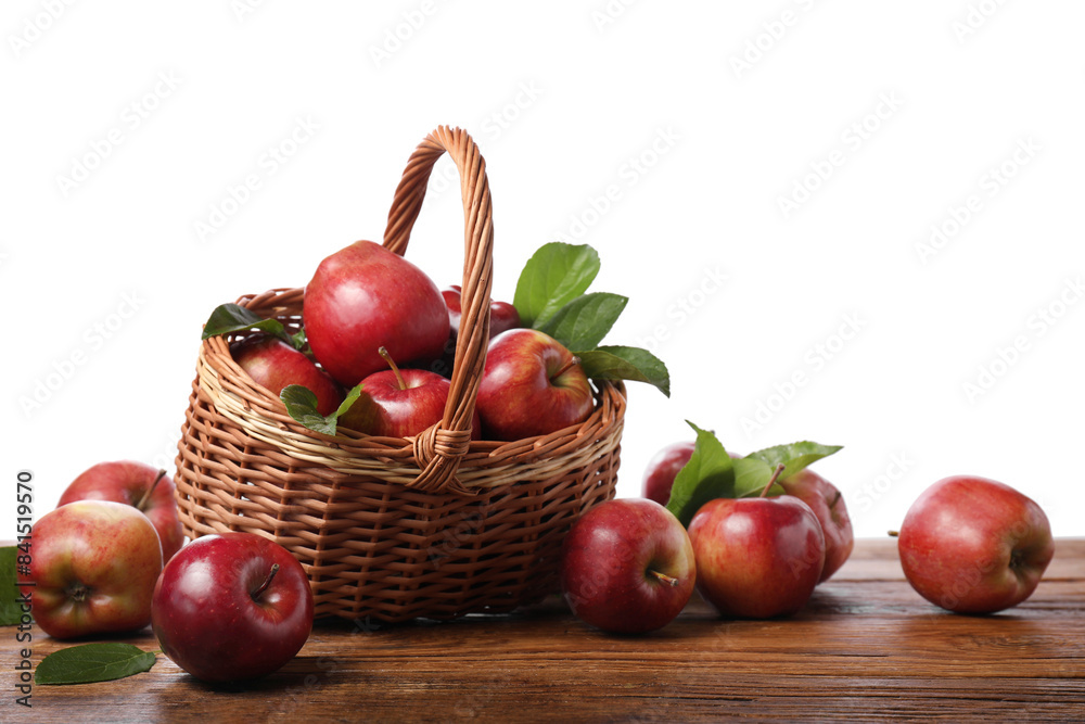 Ripe red apples and leaves on wooden table against white background Ripe red apples and leaves on wooden table against white background