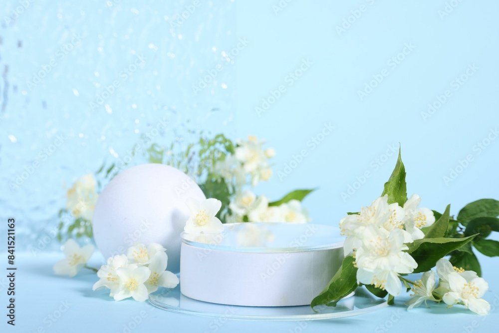 Presentation of product. White podium and beautiful jasmine flowers on light blue background Presentation of product. White podium and beautiful jasmine flowers on light blue background