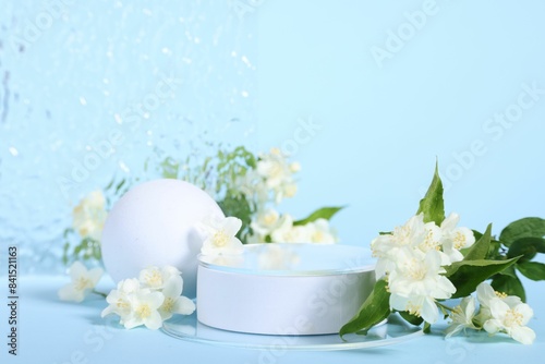 Presentation of product. White podium and beautiful jasmine flowers on light blue background