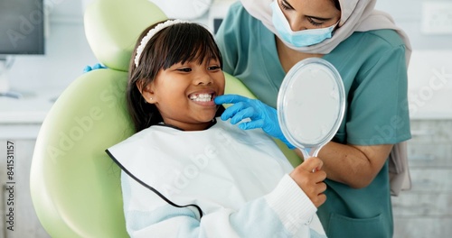 Dentist  woman and child with mirror for dental health  results and teeth cleaning service with medical advice or support. Orthodontist or doctor talking to kid or girl of tooth  procedure and mouth