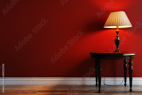 A stylish table and lamp arrangement standing out against a rich red wall, adding warmth and personality to a modern living space.