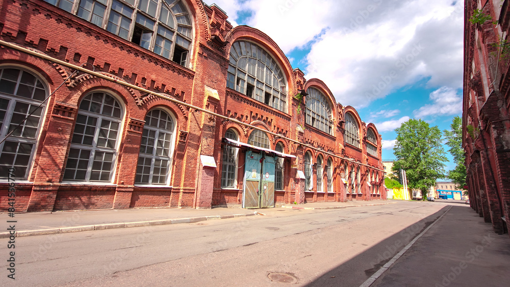 Fototapeta premium The old factory bricks building with windows and gates timelapse hyperlapse