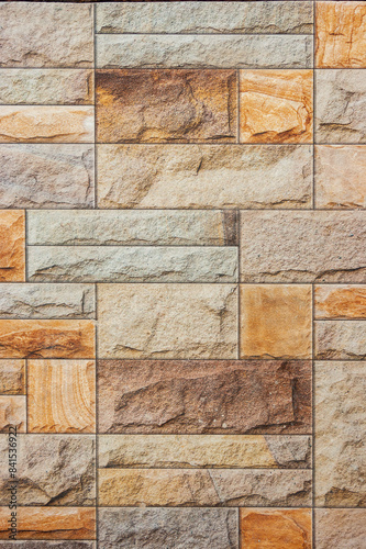 Seamless old sandstone brick wall background texture. Tileable antique vintage stone blocks or tiles surface pattern. Rustic cottagecore wallpaper or backdrop.