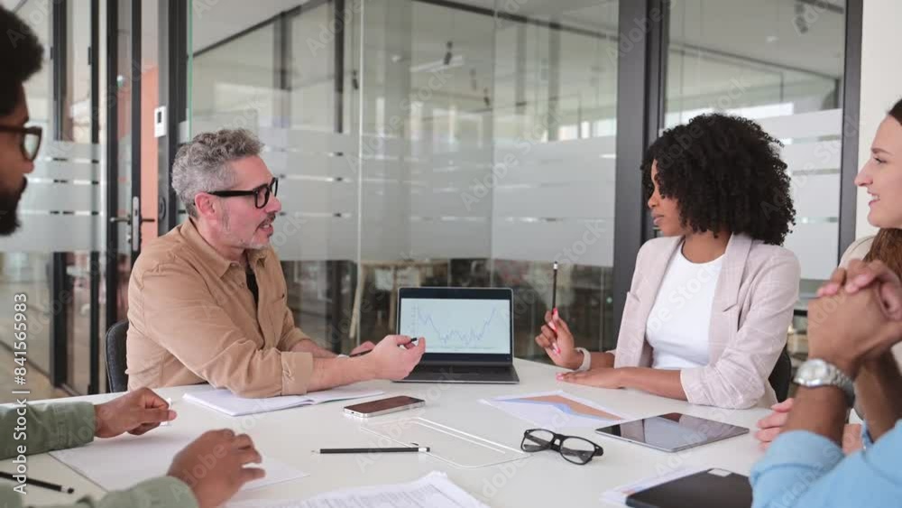 A group of four colleagues are seated casually around a laptop in a modern office space, engaged in a lively discussion, with focus on teamwork and collaborative problem-solving, brainstorming session A group of four colleagues are seated casually around a laptop in a modern office space, engaged in a lively discussion, with focus on teamwork and collaborative problem-solving, brainstorming session