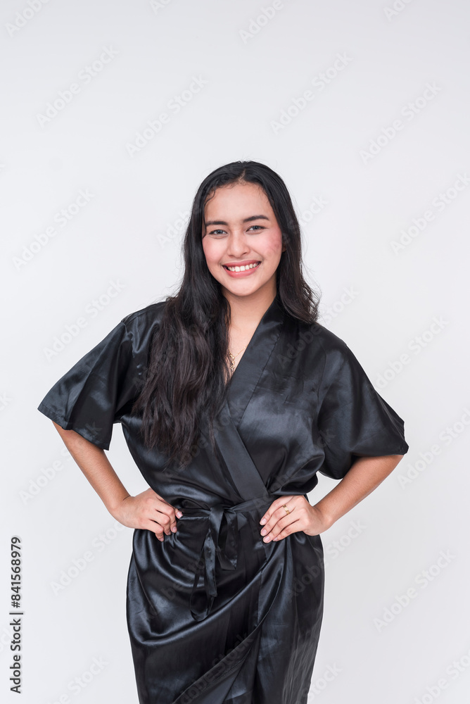 Smiling Asian woman in black silk bathrobe isolated on white background Smiling Asian woman in black silk bathrobe isolated on white background