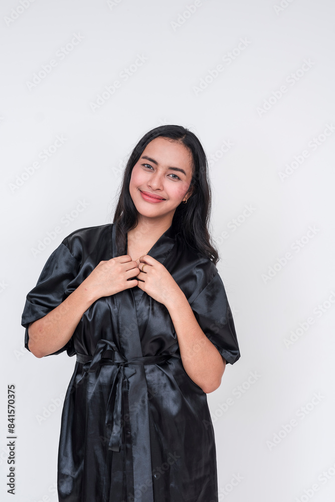 Smiling asian woman in black silk bathrobe on white background Smiling asian woman in black silk bathrobe on white background
