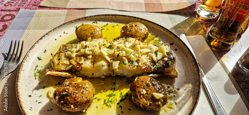 Typical portuguese dish roasted codfish with onion garlic peppers and rustic potatoes