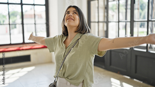 Young beautiful hispanic woman with open arms at new home © Krakenimages.com