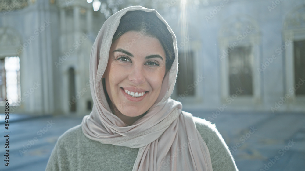 Portrait of a smiling woman in hijab inside an ornate istanbul mosque reflecting islamic architecture. Portrait of a smiling woman in hijab inside an ornate istanbul mosque reflecting islamic architecture.