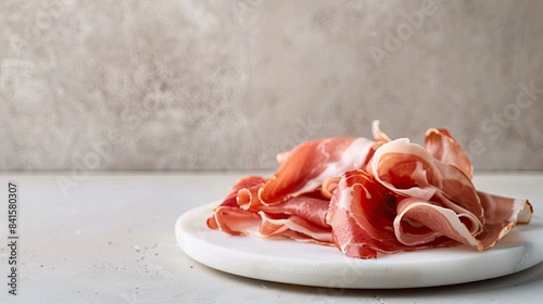 Delicate Slices of Cured Ham on a White Plate