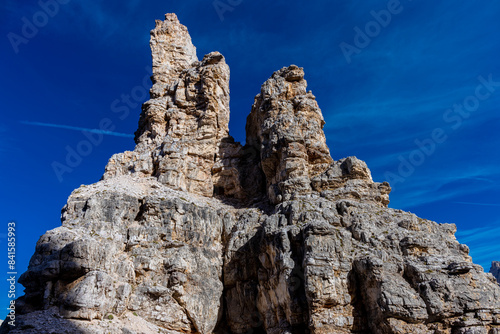 Dolomites beautiful alpine rock tower summits under blue sky in summer. Italian Alps mountains scenic landscape of rocky climbing walls in the high altitude majestic view of the cliff and green valley