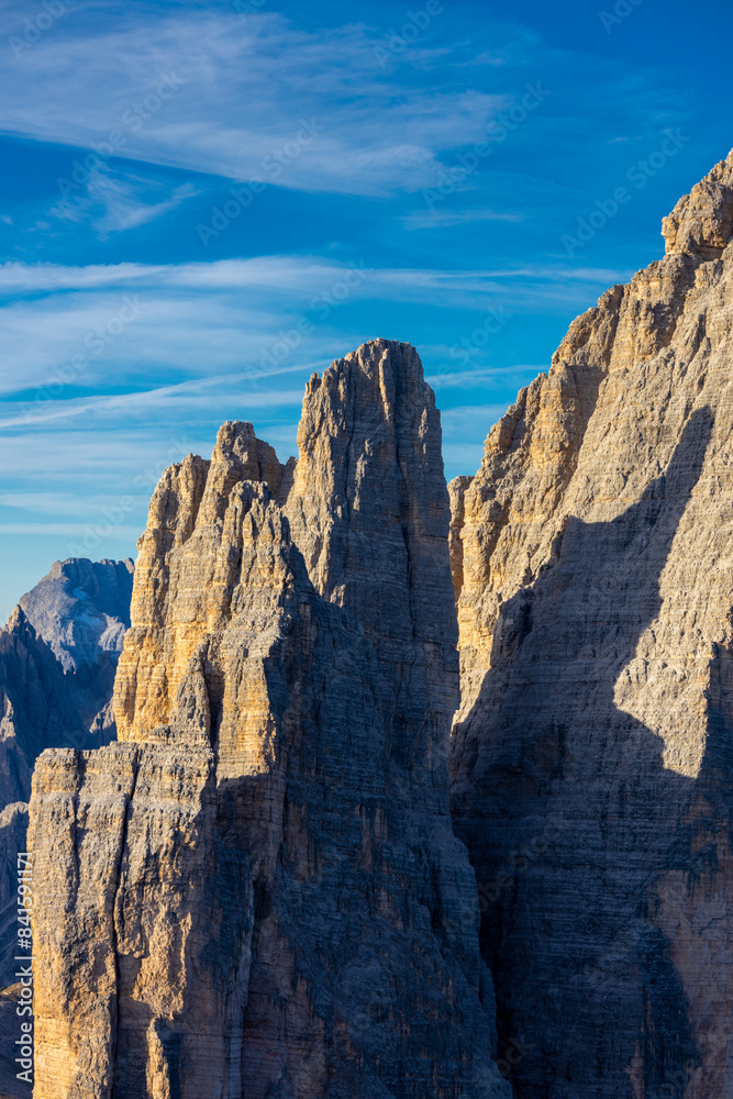 Dolomites beautiful alpine rock tower summits under blue sky in summer. Italian Alps mountains scenic landscape of rocky climbing walls in the high altitude majestic view of the cliff and green valley Dolomites beautiful alpine rock tower summits under blue sky in summer. Italian Alps mountains scenic landscape of rocky climbing walls in the high altitude majestic view of the cliff and green valley
