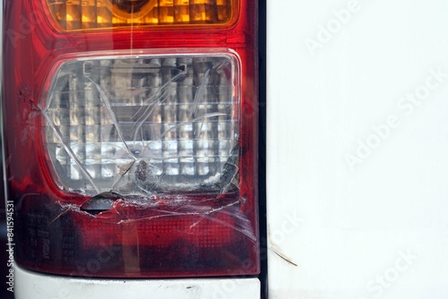 A broken a rear break light of a car.