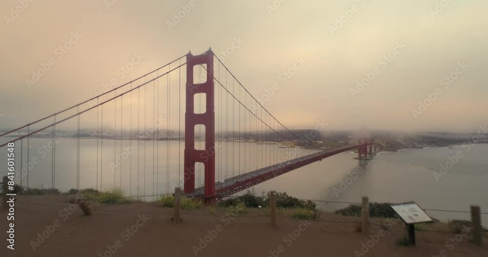 Aerial: Golden Gate Bridge at sunrise on a foggy morning, San Francisco, California, United States of America. Aerial: Golden Gate Bridge at sunrise on a foggy morning, San Francisco, California, United States of America.