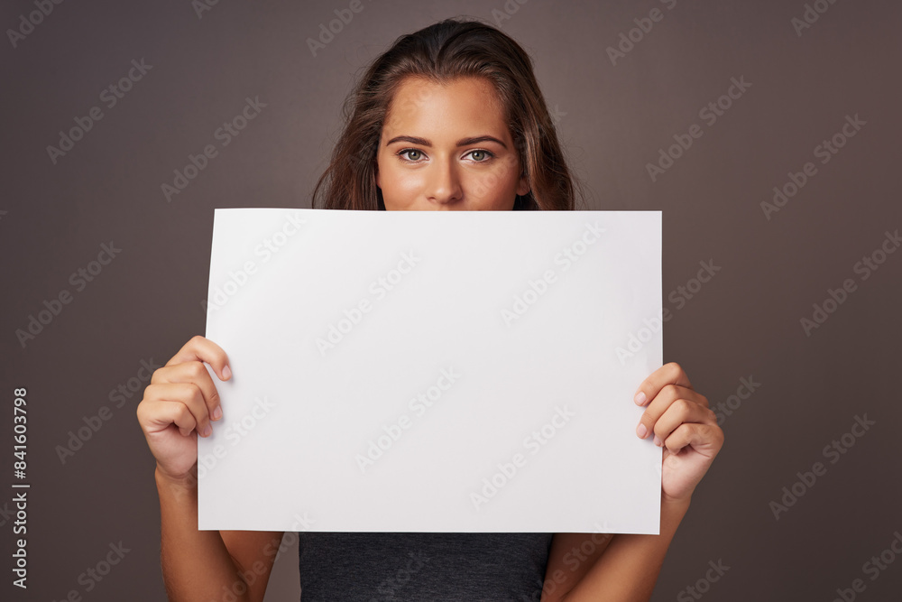 Woman, poster and studio background in portrait for promotion, mockup space and advertising with tips. Female person, sign board and presentation with instructions, information and paper card Woman, poster and studio background in portrait for promotion, mockup space and advertising with tips. Female person, sign board and presentation with instructions, information and paper card
