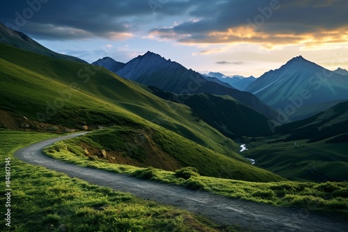 A winding road through mountains at sunset