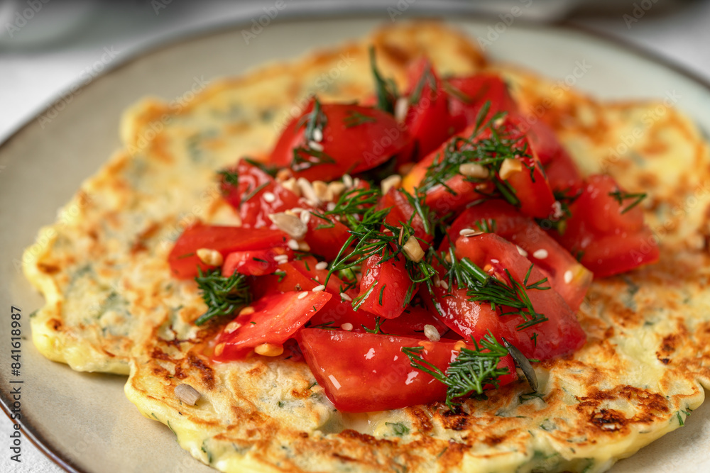 Feta and suluguni cheese tortilla with tomato and dill salsa on a bright table closeup