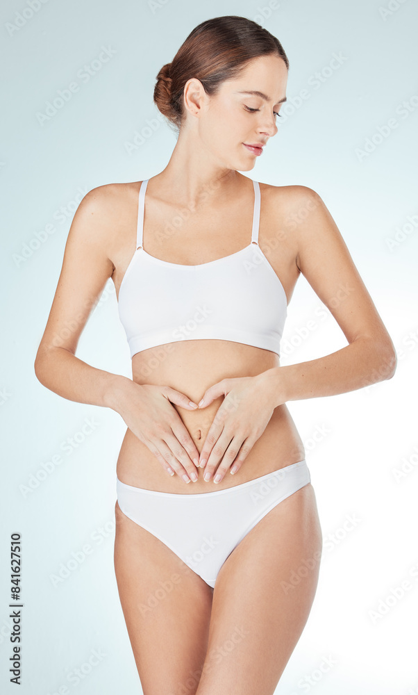 Woman, underwear and holding stomach for digestion, body care or gut health in white studio background. Female person, diet and touching tummy for wellness, nutrition and liposuction to lose weight Woman, underwear and holding stomach for digestion, body care or gut health in white studio background. Female person, diet and touching tummy for wellness, nutrition and liposuction to lose weight