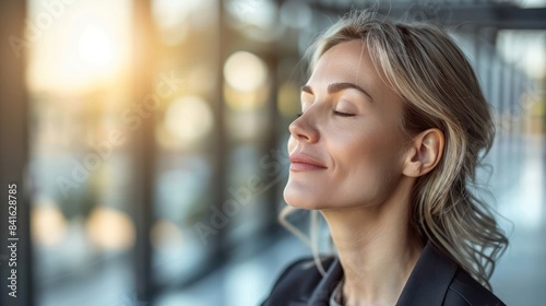 Free Download Woman with closed eyes, relaxing in a modern, glass-walled building - GFXLoad