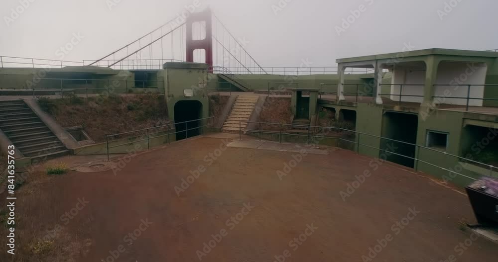 Aerial: Golden Gate Bridge and Army Bunker at sunrise on a foggy morning, San Francisco, California, United States of America. Aerial: Golden Gate Bridge and Army Bunker at sunrise on a foggy morning, San Francisco, California, United States of America.