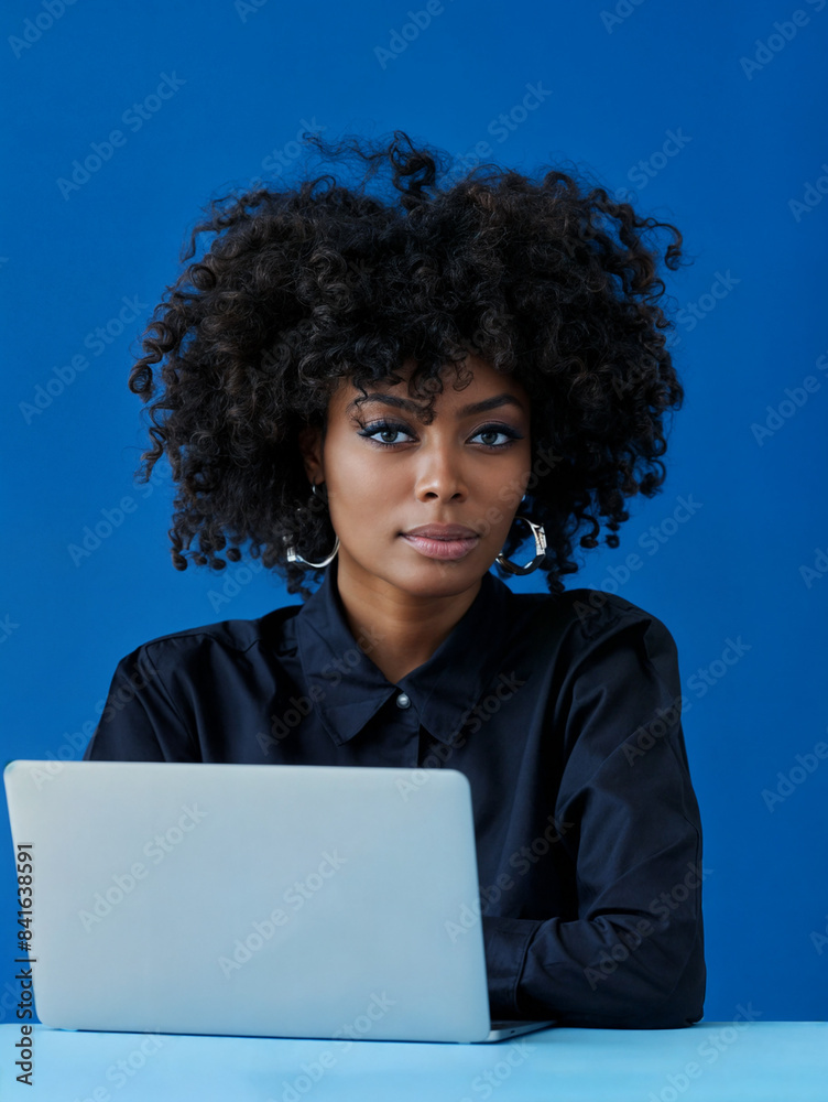 A black woman with laptop on blue background. A person with a strong personality A black woman with laptop on blue background. A person with a strong personality