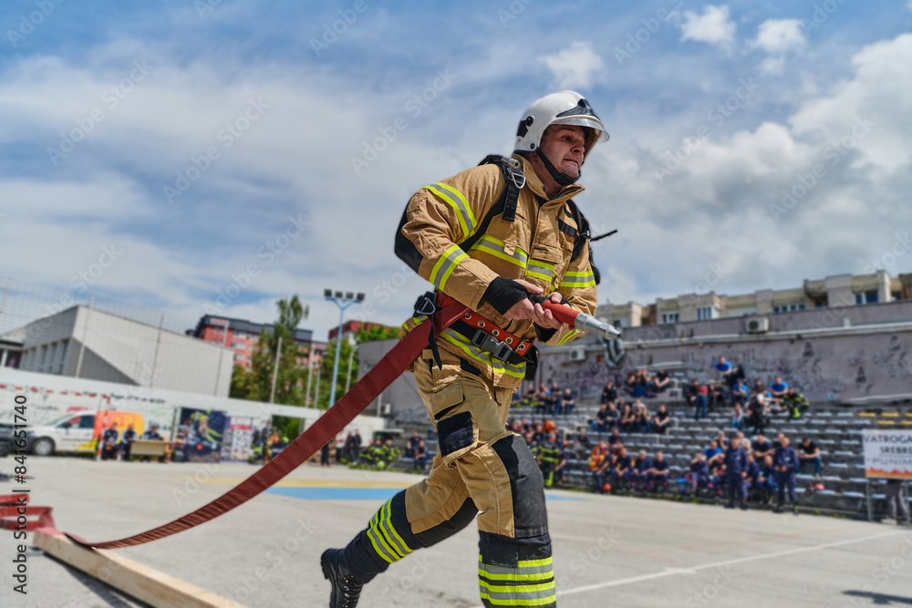 In a dynamic display of synchronized teamwork, firefighters hustle to carry, connect, and deploy firefighting hoses with precision, showcasing their intensive training and readiness for challenging In a dynamic display of synchronized teamwork, firefighters hustle to carry, connect, and deploy firefighting hoses with precision, showcasing their intensive training and readiness for challenging